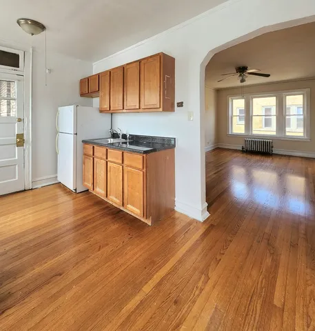 a view of a kitchen with wooden floor and a sink