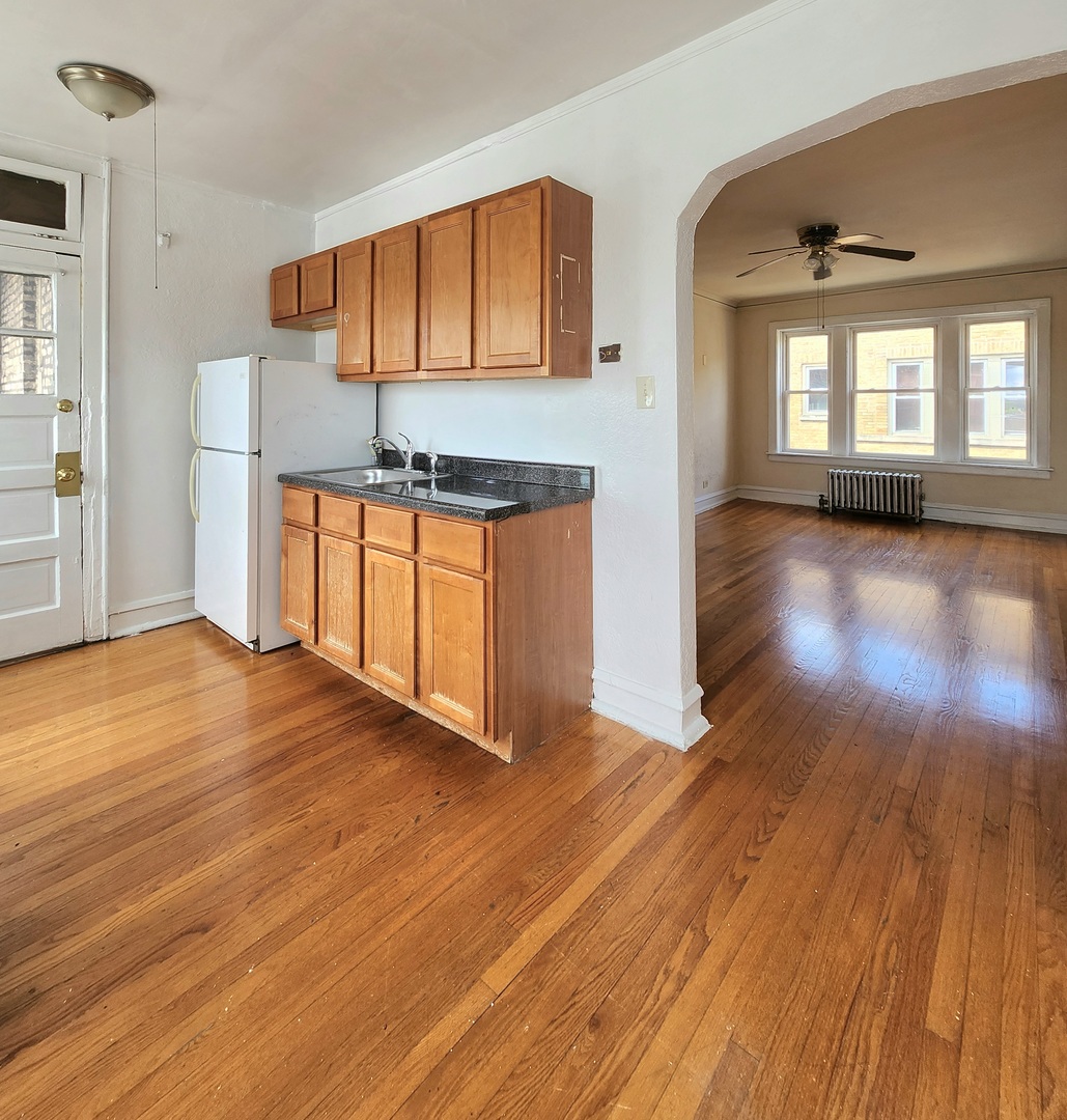 5423 West Montrose Avenue, Unit N3 Chicago, IL 60641 - Photo 3 of 10 a view of a kitchen with wooden floor and a sink