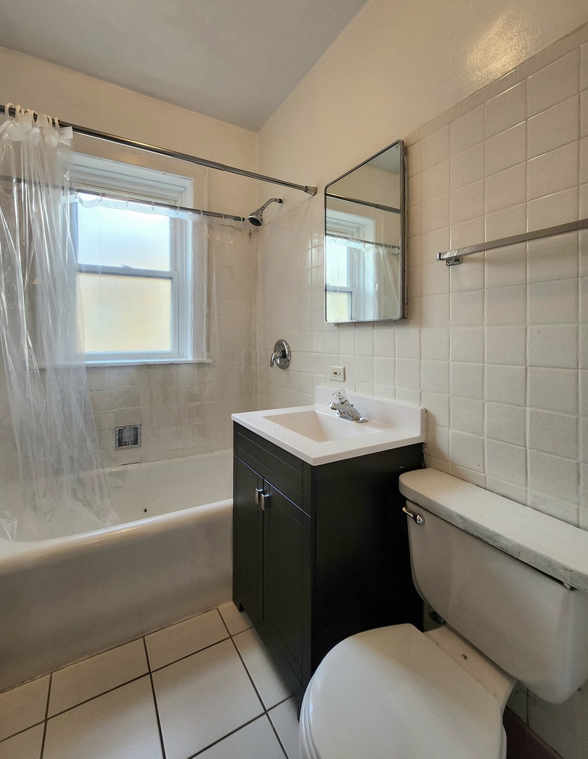 5423 West Montrose Avenue, Unit N3 Chicago, IL 60641 - Photo 9 of 10 a bathroom with a sink a toilet and shower