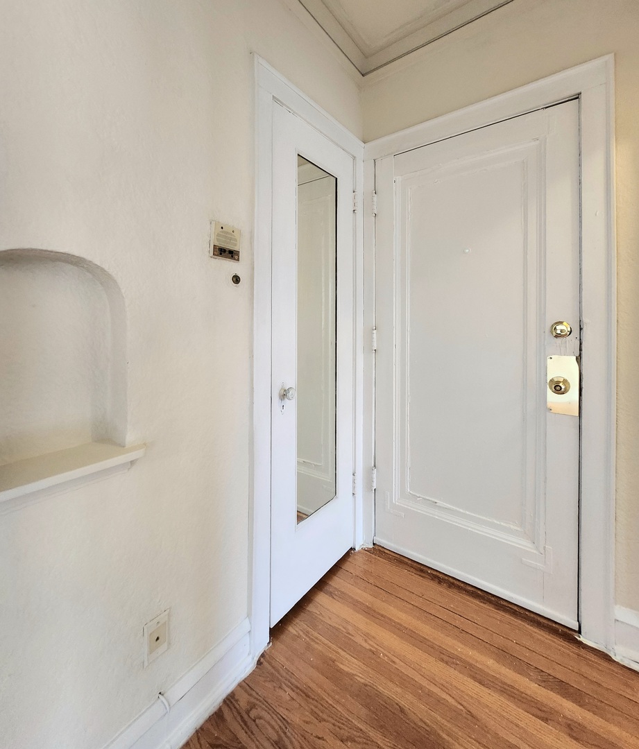 5423 West Montrose Avenue, Unit N3 Chicago, IL 60641 - Photo 10 of 10 a view of an empty room with wooden floor