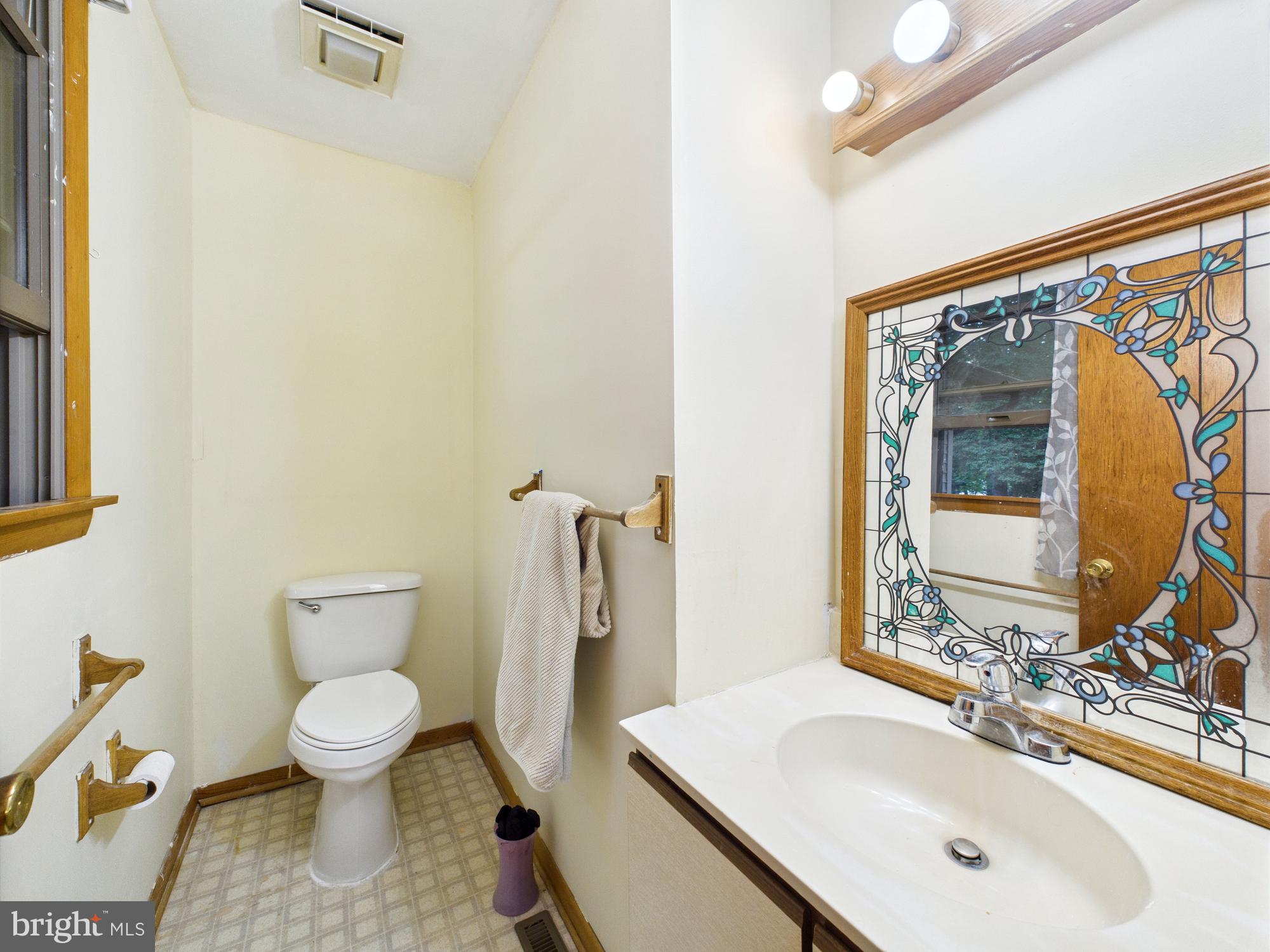 22915 Angola Road West Lewes, DE 19958 - Photo 17 of 32 a bathroom with a toilet sink and mirror