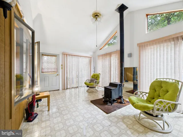 a living room with furniture chess table and a fireplace