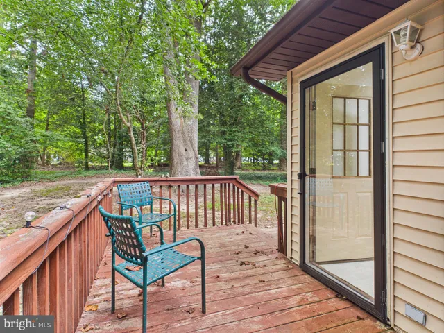 a view of a wooden deck and a backyard
