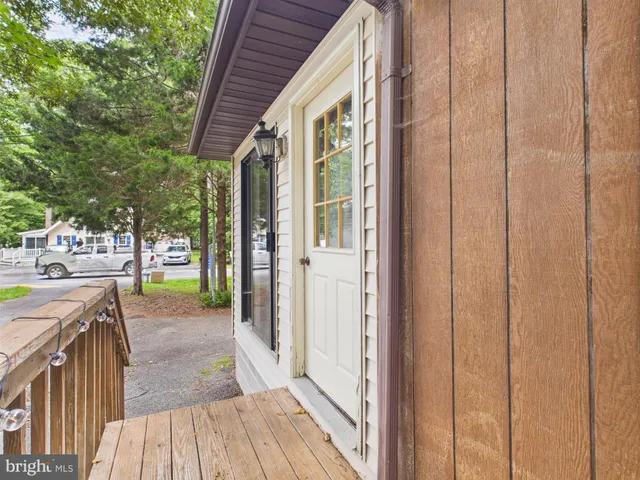 a view of a porch with wooden floor and outdoor space