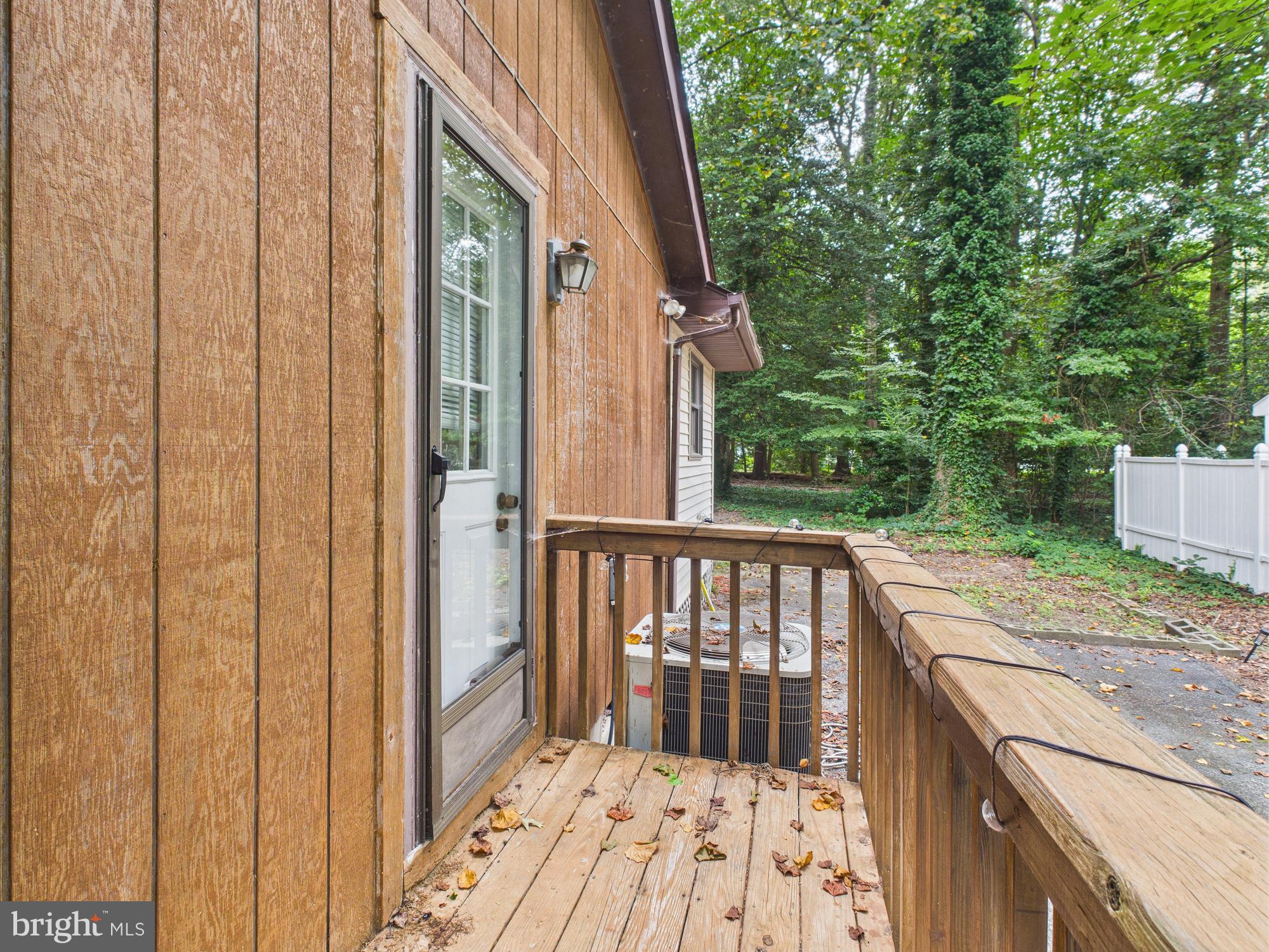 22915 Angola Road West Lewes, DE 19958 - Photo 25 of 32 a view of a porch with wooden floor and outdoor space
