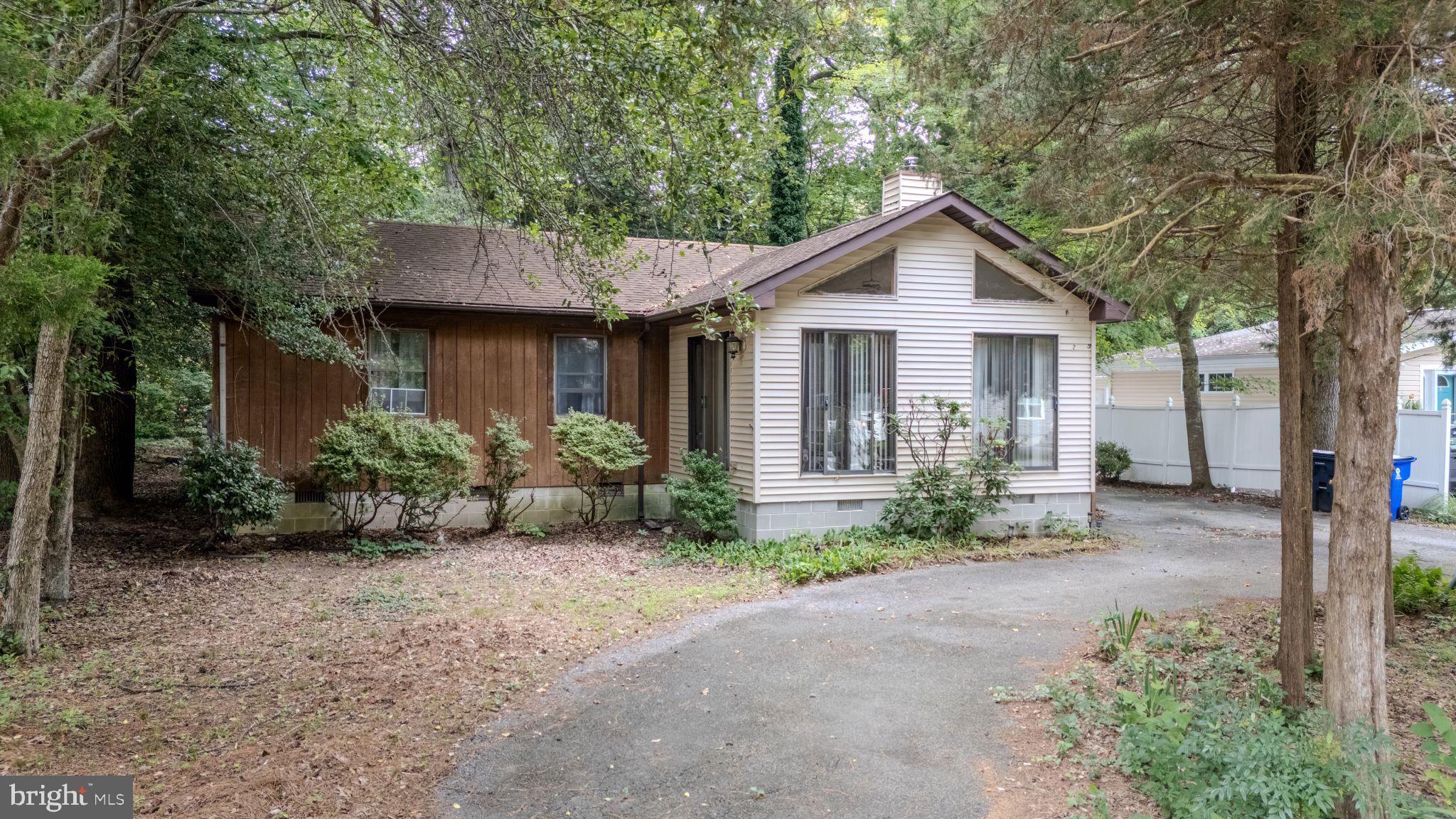 22915 Angola Road West Lewes, DE 19958 - Photo 26 of 32 a view of a house with a small yard and large tree