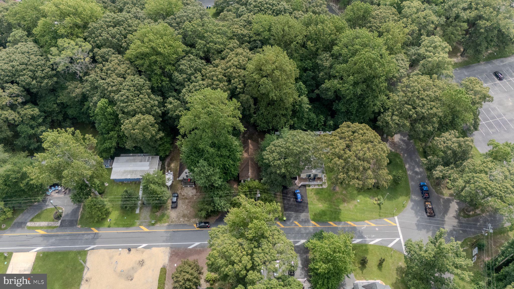 22915 Angola Road West Lewes, DE 19958 - Photo 30 of 32 an aerial view of residential house with outdoor space and trees all around