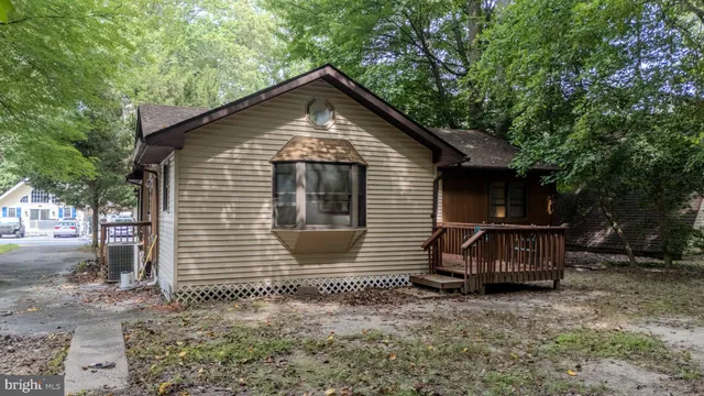 a view of a house with a yard and deck