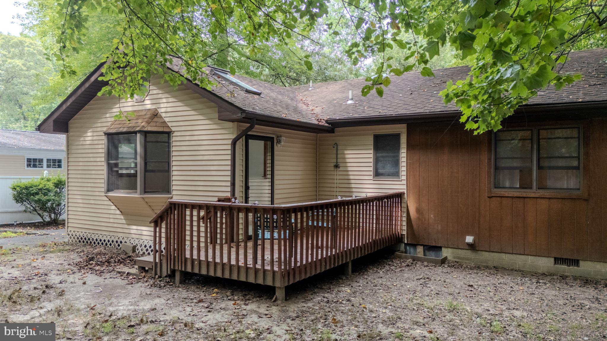 22915 Angola Road West Lewes, DE 19958 - Photo 32 of 32 a view of a house with a yard and deck