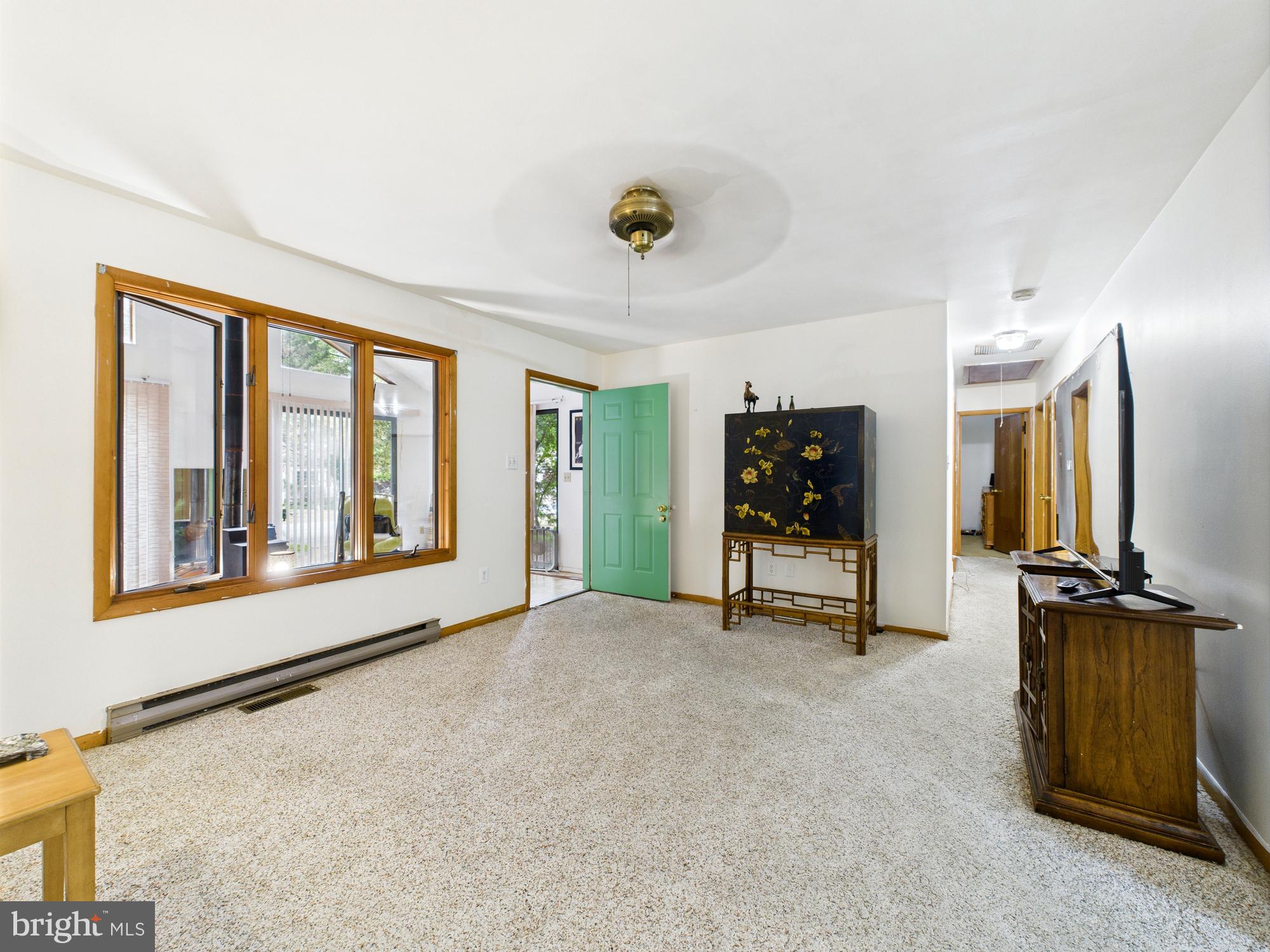 22915 Angola Road West Lewes, DE 19958 - Photo 5 of 32 a view of an empty room with furniture and a flat screen tv