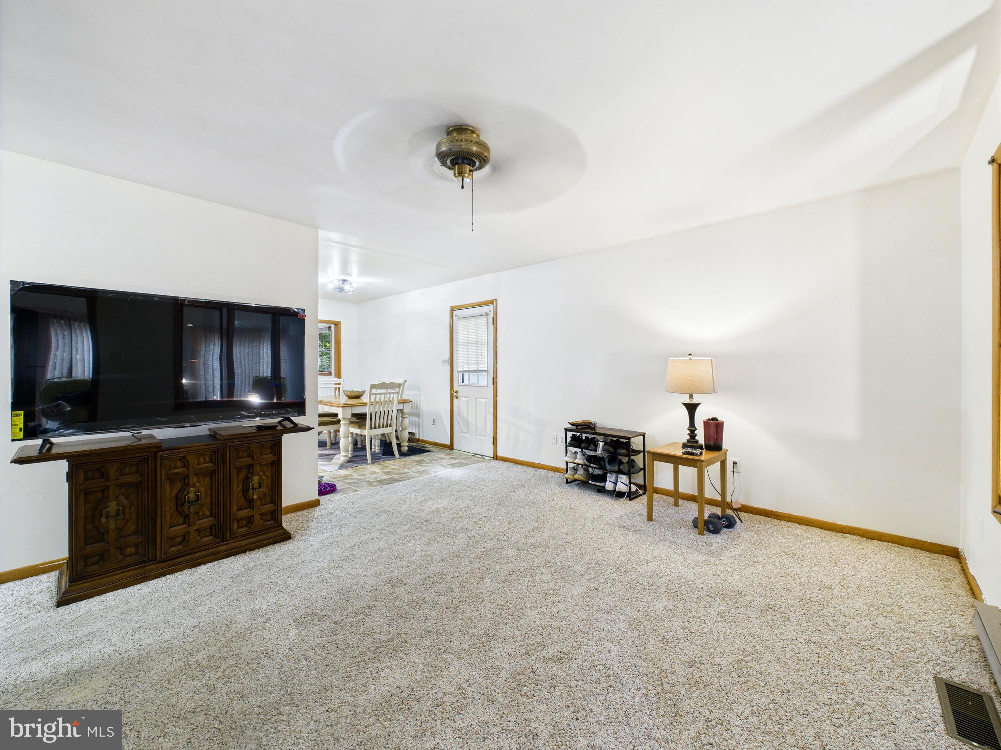 22915 Angola Road West Lewes, DE 19958 - Photo 6 of 32 a living room with furniture and a flat screen tv
