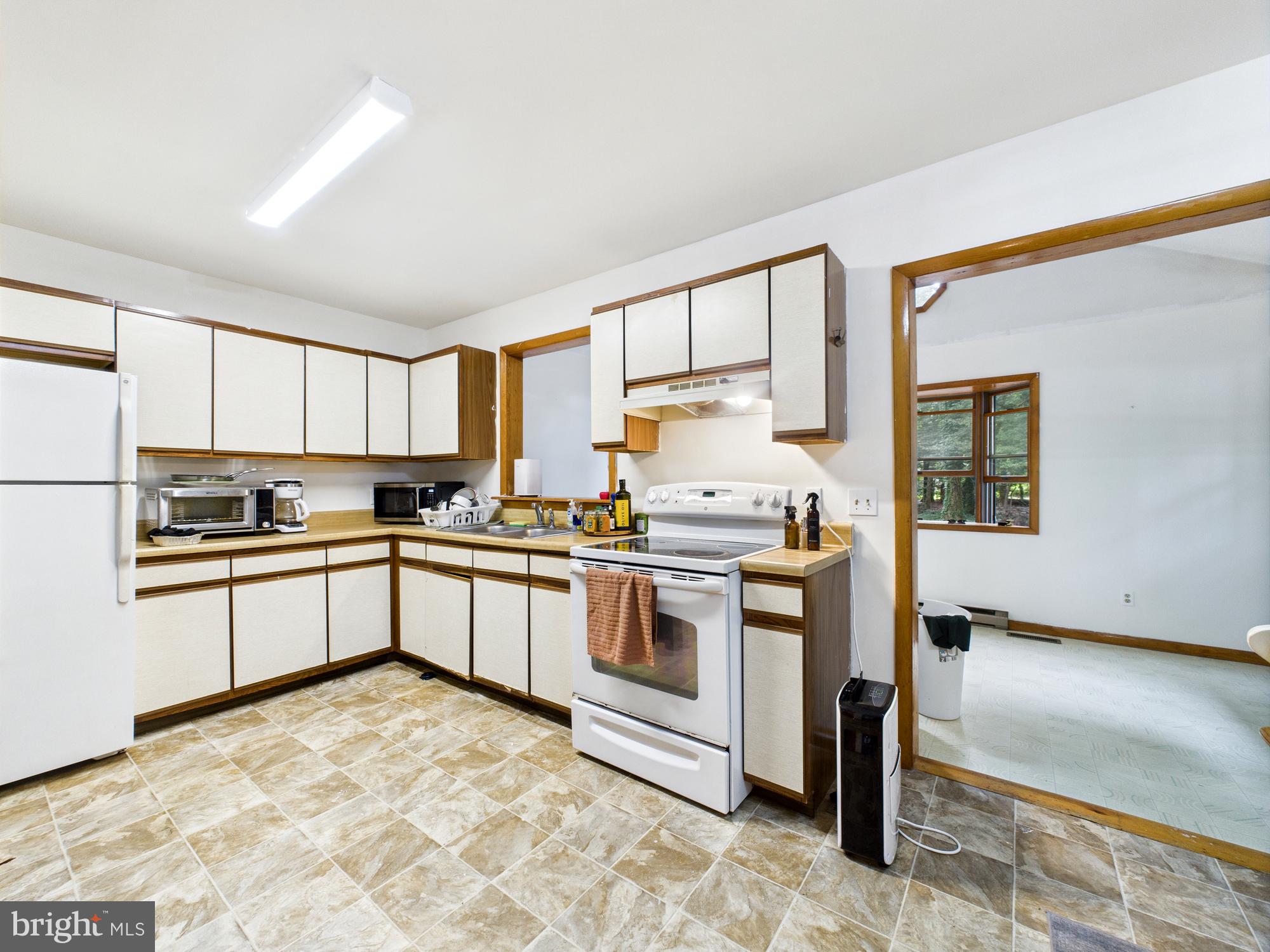 22915 Angola Road West Lewes, DE 19958 - Photo 8 of 32 a kitchen with stainless steel appliances granite countertop a stove a sink and a refrigerator