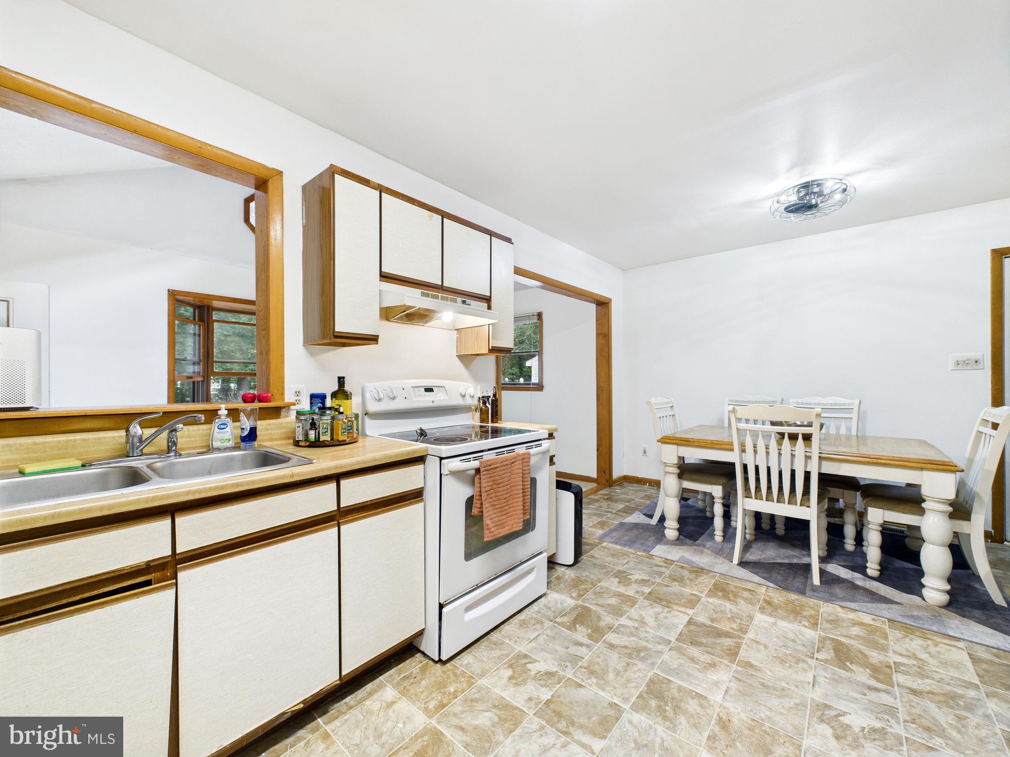 22915 Angola Road West Lewes, DE 19958 - Photo 9 of 32 a kitchen with a sink and chairs