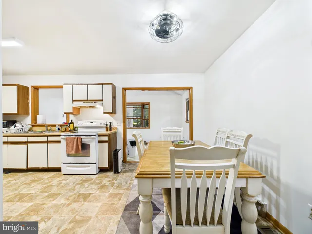 a view of a dining room with furniture and washer dryer