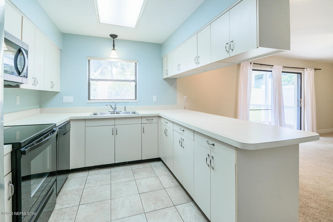 2233 Seminole Road, Unit 30 Atlantic Beach, FL 32233 - Photo 11 of 29 a kitchen with a sink window and cabinets