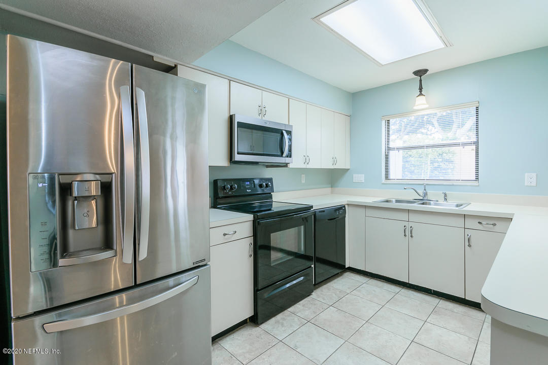 2233 Seminole Road, Unit 30 Atlantic Beach, FL 32233 - Photo 12 of 29 a kitchen with granite countertop cabinets stainless steel appliances and a window