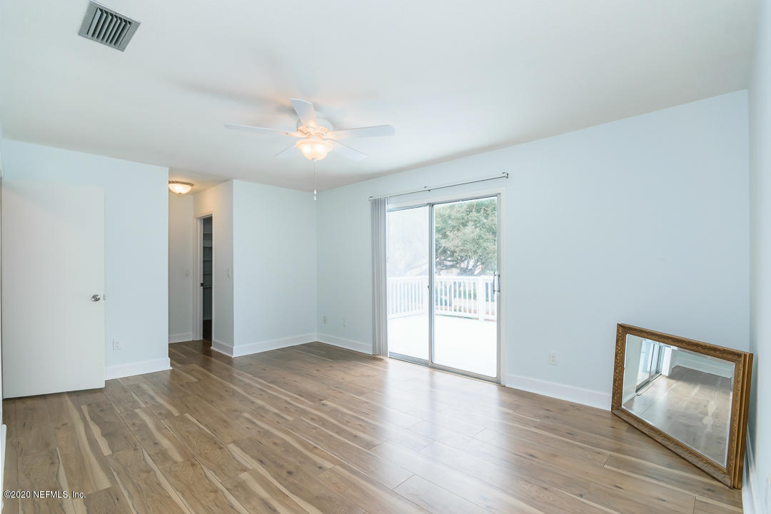 2233 Seminole Road, Unit 30 Atlantic Beach, FL 32233 - Photo 16 of 29 an empty room with wooden floor and windows