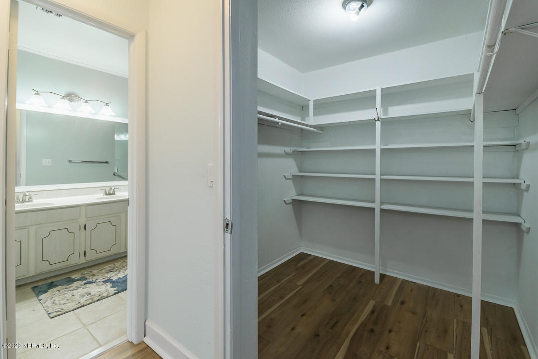 2233 Seminole Road, Unit 30 Atlantic Beach, FL 32233 - Photo 17 of 29 a view of walk in closet with wooden floor
