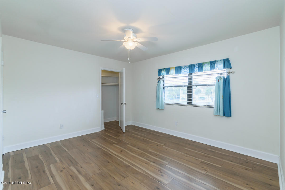 2233 Seminole Road, Unit 30 Atlantic Beach, FL 32233 - Photo 19 of 29 a view of an empty room with wooden floor and a window