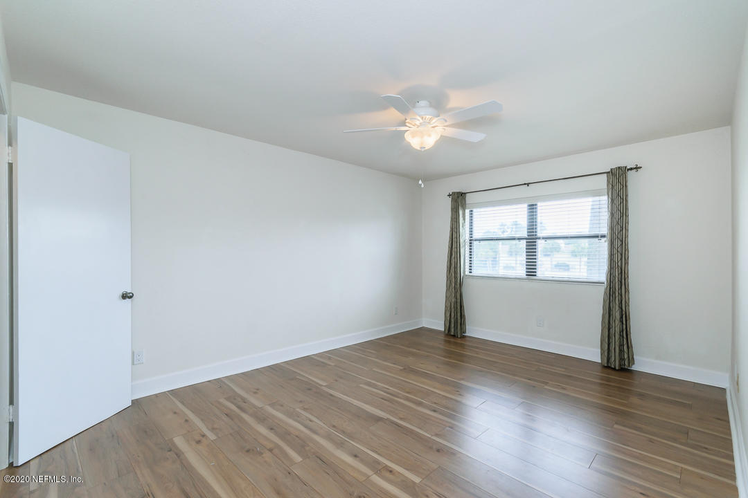 2233 Seminole Road, Unit 30 Atlantic Beach, FL 32233 - Photo 20 of 29 an empty room with wooden floor and windows