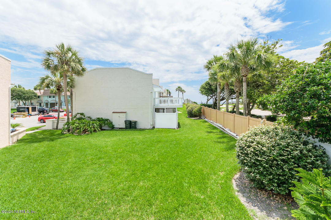 2233 Seminole Road, Unit 30 Atlantic Beach, FL 32233 - Photo 24 of 29 a view of a backyard with potted plants and a large tree