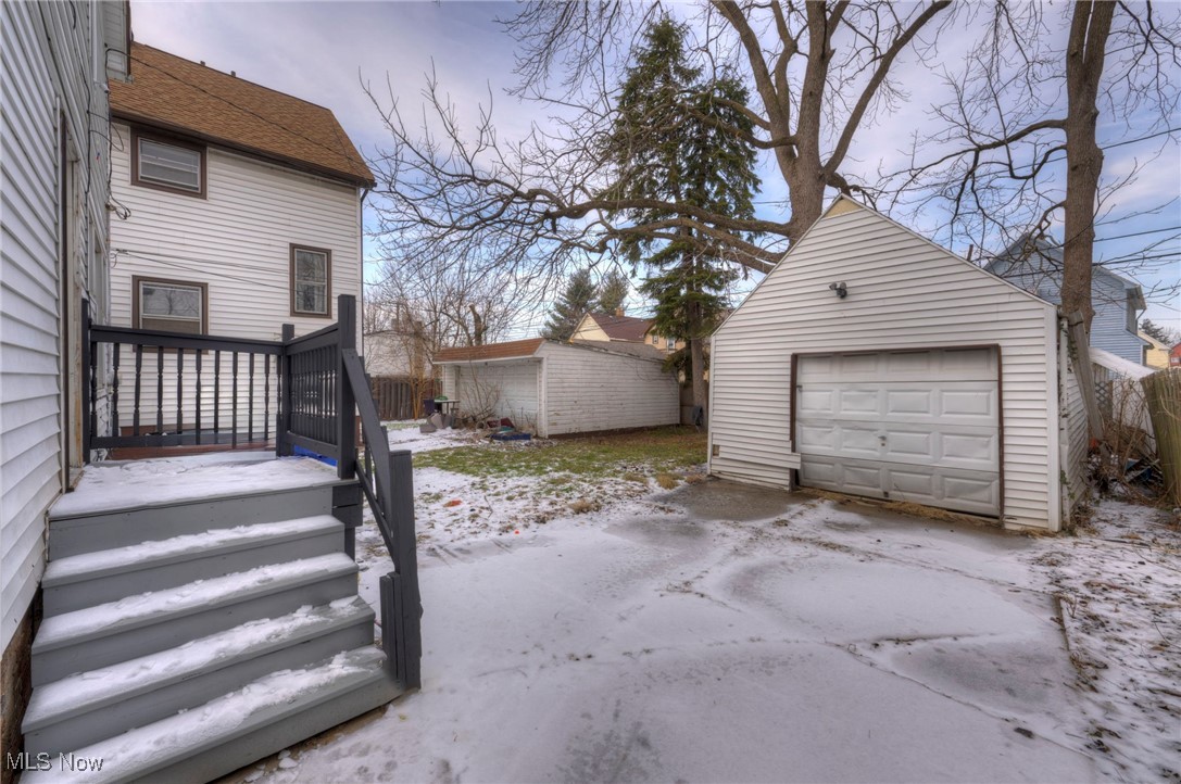 4324 Riverside Avenue Cleveland, OH 44102 - Photo 3 of 8 Yard layered in snow featuring a garage, an outdoor structure, and driveway