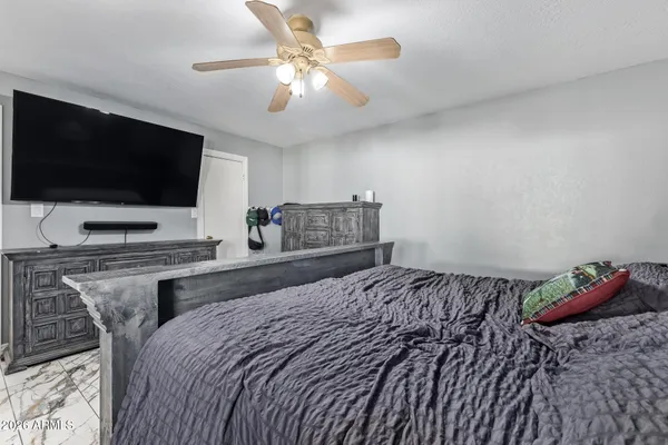 a bedroom with a bed and a flat screen tv