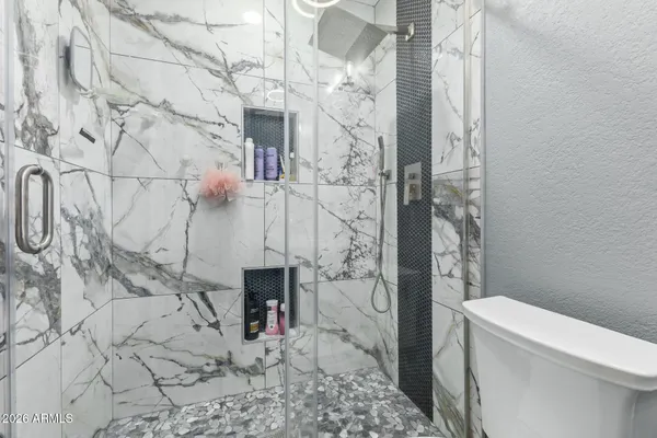 a bathroom with a toilet and shower