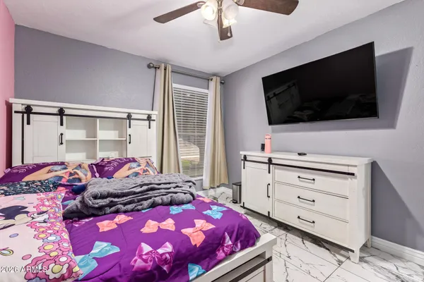 a bedroom with a bed and flat screen tv
