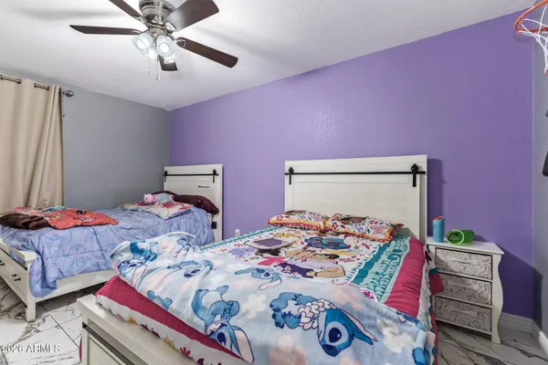 a bedroom with bed and wooden floor
