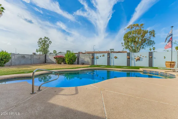 a view of a swimming pool with a yard