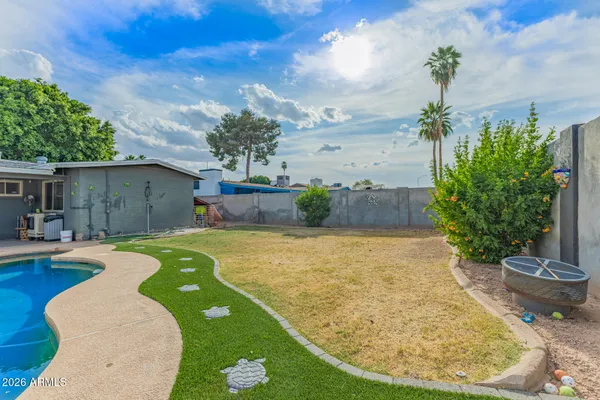 a view of a swimming pool in the backyard
