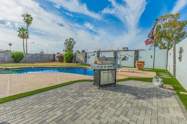 a swimming pool with yard in front of it