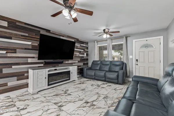 a living room with furniture and a flat screen tv