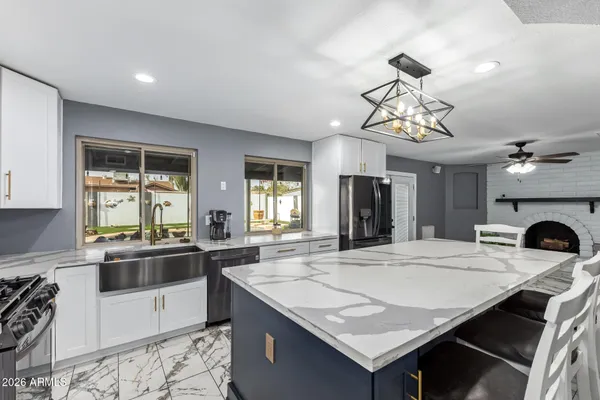 a kitchen with a stove a sink and a refrigerator