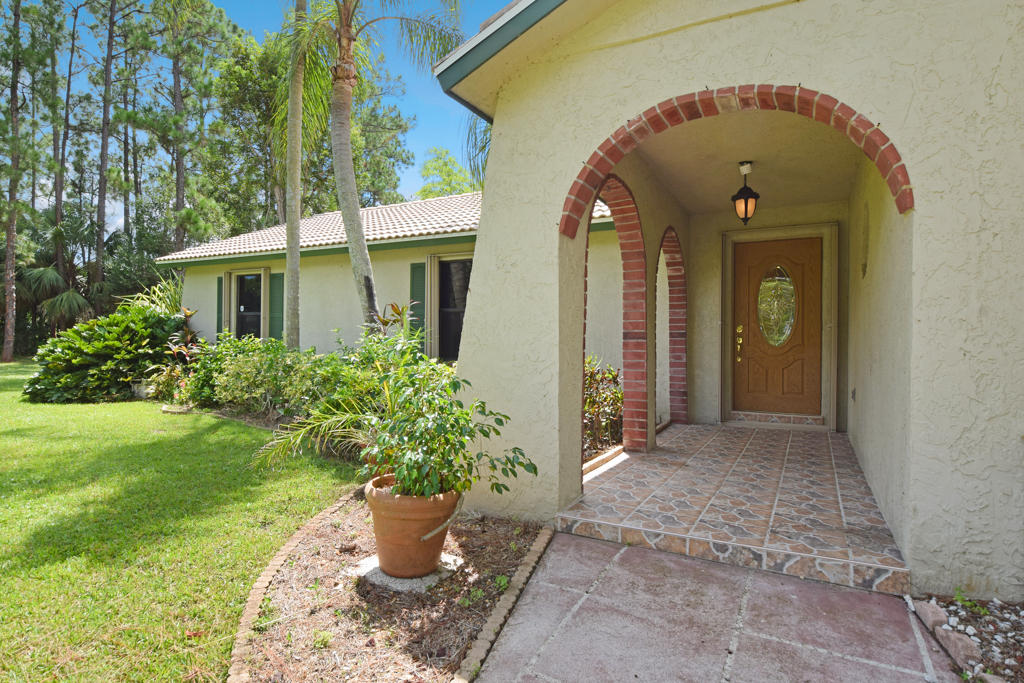 15429 Jupiter Farms Road Jupiter, FL 33478 - Photo 20 of 59 a front view of a house with a porch
