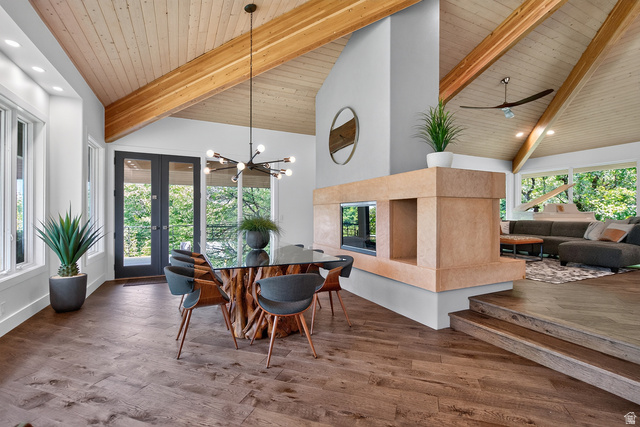 11454 South Oberland Road Sandy, UT 84092 - Photo 26 of 103 Vaulted wood-paneled ceilings with exposed beams, wood-finish flooring, and a stone-clad fireplace with a pass-through opening