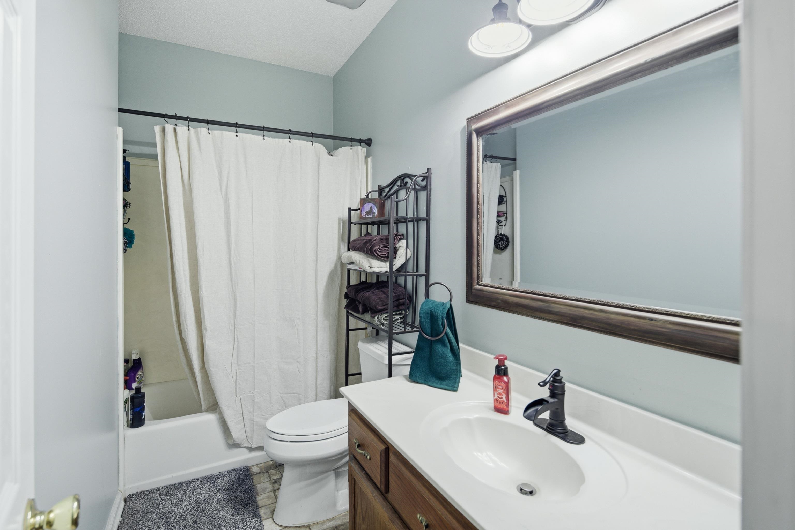 1755 Country Club Road Somerville, TN 38068 - Photo 31 of 40 Bathroom with vanity and shower / bathtub combination with curtain