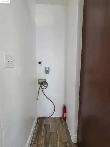 a view of a room with wooden floor