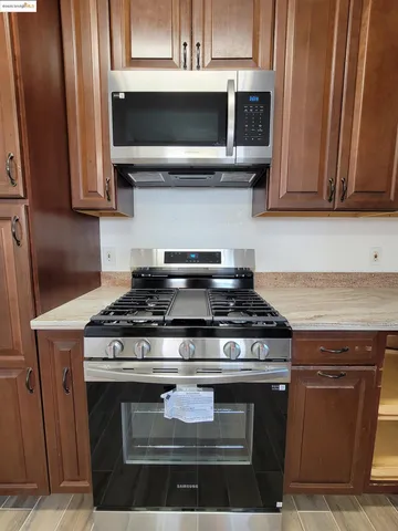 a stove top oven sitting inside of a kitchen