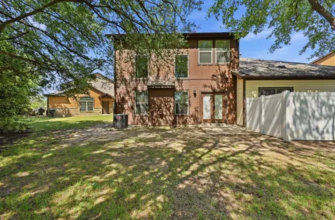 a view of a house with a tree