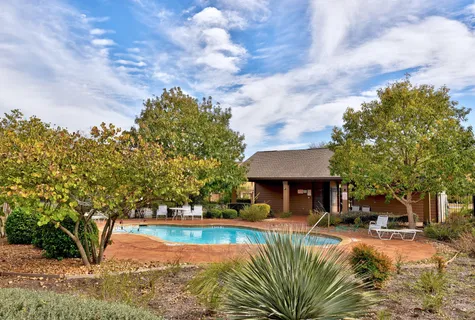 a view of a swimming pool with a patio
