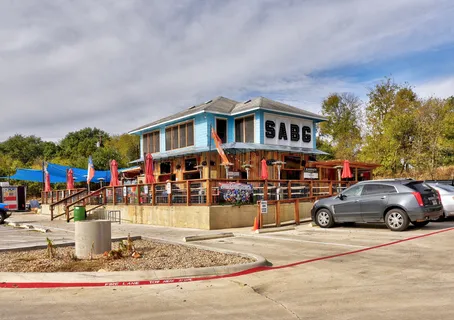 a front view of a house with cars parked