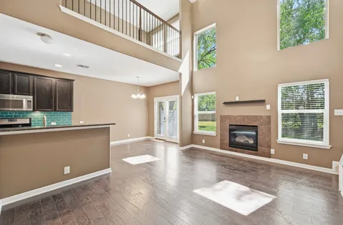 a view of an empty room with a fireplace and a window