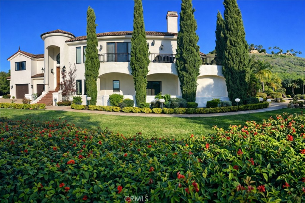 a front view of multi story residential apartment building with yard and retail shops