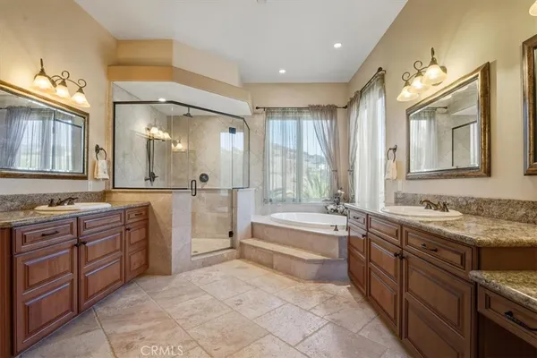 a spacious bathroom with a granite countertop tub sink and a mirror