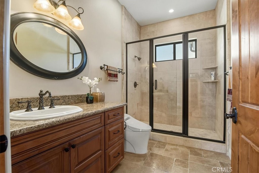 775 Riata Lane Nipomo, CA 93444 - Photo 18 of 48 a bathroom with a granite countertop sink toilet and a mirror