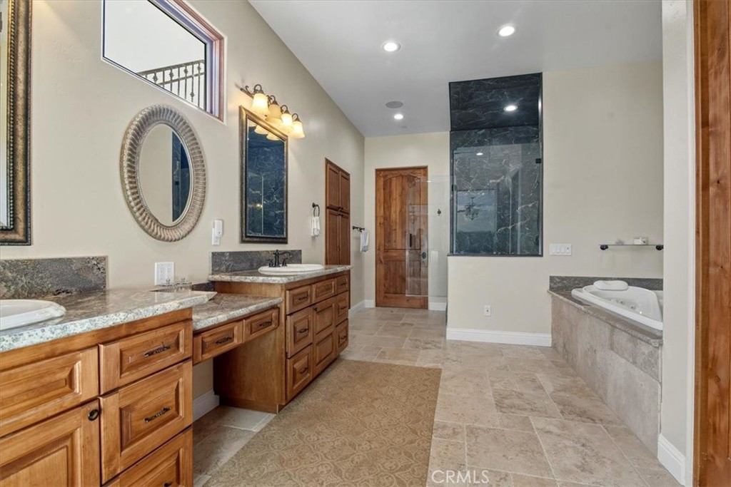 775 Riata Lane Nipomo, CA 93444 - Photo 22 of 48 a spacious bathroom with a granite countertop tub sink and a mirror