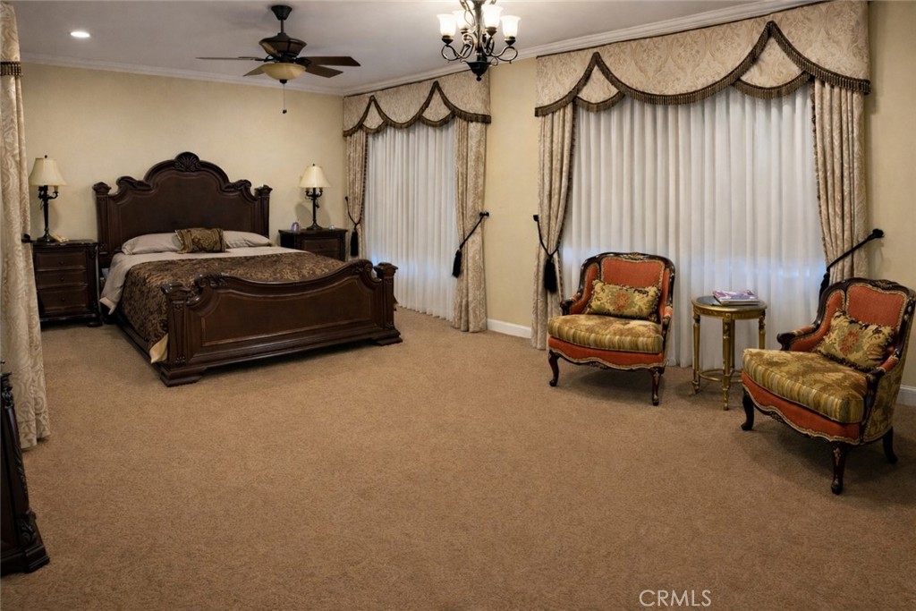 775 Riata Lane Nipomo, CA 93444 - Photo 26 of 40 a bedroom with furniture and a chandelier