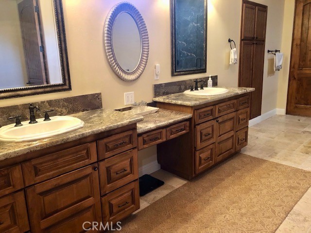775 Riata Lane Nipomo, CA 93444 - Photo 27 of 40 a bathroom with a granite countertop double vanity sink and a mirror